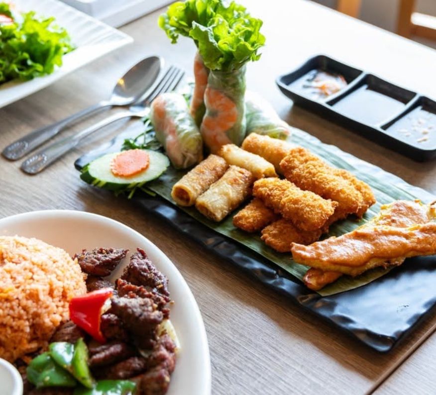Assorted Thai and Vietnamese appetizers at Red Chili including fresh shrimp rolls, fried spring rolls, and chicken satay served table-side